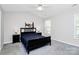 Calm bedroom featuring neutral tones, vaulted ceilings, and two windows for natural light at 5943 Pisgah Way, Charlotte, NC 28217