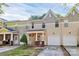Charming two-story townhouse featuring attached garage and cozy front porch at 5943 Pisgah Way, Charlotte, NC 28217