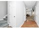 Bright hallway features hardwood floors, neutral walls, and access to the dining room and stairs at 5943 Pisgah Way, Charlotte, NC 28217
