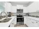 Modern kitchen boasts white cabinets, stainless steel appliances and bright countertops at 5943 Pisgah Way, Charlotte, NC 28217