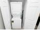 Laundry room features a stacked washer and dryer, providing convenience and space-saving design at 5943 Pisgah Way, Charlotte, NC 28217