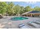 Community pool with lounge chairs and clubhouse surrounded by mature trees at 5943 Pisgah Way, Charlotte, NC 28217