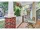 Inviting front porch with brick pillars, white railings, and hanging flower baskets at 5943 Pisgah Way, Charlotte, NC 28217