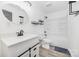 The bright bathroom has a modern vanity, stylish mirror, shelving, and a shower-tub combo at 611 Fernwood Dr, Albemarle, NC 28001