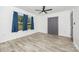 This bedroom is freshly painted with wood-look flooring, ceiling fan, and window with natural light at 611 Fernwood Dr, Albemarle, NC 28001