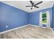 This stylish bedroom has wood-look flooring, a ceiling fan, and a window with peaceful views at 611 Fernwood Dr, Albemarle, NC 28001