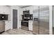 This kitchen features stainless steel appliances and a black tile backsplash at 611 Fernwood Dr, Albemarle, NC 28001