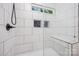 Shower showcasing white tiles, a built-in bench, and hexagon accent tile at 611 Fernwood Dr, Albemarle, NC 28001