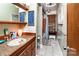 Well-lit bathroom features tile floor, wood accents, decor, and walk-in shower with a bamboo shade at 6516 Sharon Hills Rd, Charlotte, NC 28210