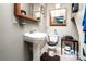 Traditional bathroom includes toilet, pedestal sink, mirrored cabinet, and a dark brown rug at 6516 Sharon Hills Rd, Charlotte, NC 28210