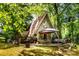 Charming A-frame home with a patio surrounded by lush trees at 6516 Sharon Hills Rd, Charlotte, NC 28210