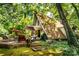 A-frame home with a backyard patio surrounded by trees and greenery at 6516 Sharon Hills Rd, Charlotte, NC 28210