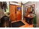 Stylish foyer featuring wood door, wood accents, and decorative furnishings at 6516 Sharon Hills Rd, Charlotte, NC 28210