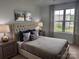 Comfortable bedroom featuring neutral walls, tufted headboard and a window view at 704 Robert Moses Dr # 121, Gastonia, NC 28056