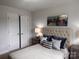 Well-decorated bedroom featuring a tufted headboard and neutral bedding with geometric pillows at 704 Robert Moses Dr # 121, Gastonia, NC 28056