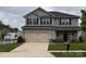 Charming two-story home with a two car garage, beautifully landscaped yard, and gray siding at 704 Robert Moses Dr # 121, Gastonia, NC 28056