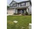 Charming two-story home with a two car garage, beautifully landscaped yard, and gray siding at 704 Robert Moses Dr # 121, Gastonia, NC 28056