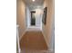 Hallway with neutral carpeting, light walls, and access to multiple rooms at 704 Robert Moses Dr # 121, Gastonia, NC 28056
