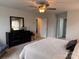 Main bedroom featuring a ceiling fan, a large dresser, and a bathroom doorway at 704 Robert Moses Dr # 121, Gastonia, NC 28056