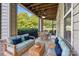 Relaxing screened-in back porch with comfortable seating, ceiling fan, and an outdoor dining table at 9047 Rosalyn Glen Rd, Cornelius, NC 28031