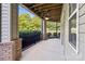 A comfortable screened-in back porch featuring brick columns and peaceful views of the manicured backyard at 9047 Rosalyn Glen Rd, Cornelius, NC 28031