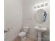 Well-lit powder room with pedestal sink and ceramic tile flooring, offering a clean and functional space at 9047 Rosalyn Glen Rd, Cornelius, NC 28031