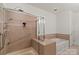 Bathroom featuring a walk-in shower and soaking tub at 9047 Rosalyn Glen Rd, Cornelius, NC 28031