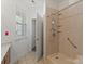 Bathroom featuring a walk-in shower and window at 9047 Rosalyn Glen Rd, Cornelius, NC 28031