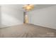 Spacious bedroom featuring a ceiling fan and neutral carpet at 9047 Rosalyn Glen Rd, Cornelius, NC 28031