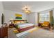 Inviting bedroom with a ceiling fan, mid-century decor, and abundant natural light, ensuring comfort and style at 9047 Rosalyn Glen Rd, Cornelius, NC 28031