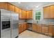 Functional kitchen with stainless steel appliances and plentiful wood cabinetry, offering ample storage and workspace at 9047 Rosalyn Glen Rd, Cornelius, NC 28031