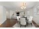 Open-concept living and dining room with hardwood floors, light walls, and stylish furniture, ready to move in at 9047 Rosalyn Glen Rd, Cornelius, NC 28031