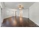 Spacious living area featuring gleaming hardwood floors and abundant natural light, perfect for entertaining and relaxing at 9047 Rosalyn Glen Rd, Cornelius, NC 28031