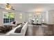Inviting living space that features hardwood floors, a dining area, a comfortable sofa and ample natural light at 9047 Rosalyn Glen Rd, Cornelius, NC 28031
