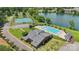 An aerial view of community amenities including a pool, clubhouse, tennis courts and lake with blue skies at 907 Ospre Ln, Fort Mill, SC 29708