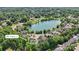 An aerial shot shows a neighborhood with lush trees and a labeled home, near a lake, offering scenic views at 907 Ospre Ln, Fort Mill, SC 29708