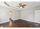Bright and airy bedroom with tray ceiling and adjacent bathroom, featuring hardwood floors at 907 Ospre Ln, Fort Mill, SC 29708