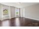 Bright bedroom features hardwood floors, a ceiling fan and bright white trim at 907 Ospre Ln, Fort Mill, SC 29708