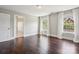 Bright bedroom features hardwood floors, a ceiling fan and bright white trim at 907 Ospre Ln, Fort Mill, SC 29708