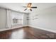 Bright bedroom features hardwood floors, a ceiling fan and bright white trim at 907 Ospre Ln, Fort Mill, SC 29708