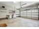 Spacious garage with concrete floor, automatic door, and storage shelves and cabinets along the left wall at 907 Ospre Ln, Fort Mill, SC 29708