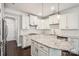 Bright, modern kitchen with granite countertops, stainless steel appliances, and white cabinetry at 907 Ospre Ln, Fort Mill, SC 29708
