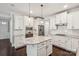 Bright kitchen with white cabinets, granite countertops, stainless steel appliances and large island at 907 Ospre Ln, Fort Mill, SC 29708