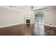 Open living space with hardwood floors, fireplace, and sliding glass doors to backyard at 907 Ospre Ln, Fort Mill, SC 29708