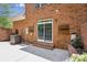 Brick patio with a sliding glass door, brick steps, storage and plants, and an air conditioning unit at 907 Ospre Ln, Fort Mill, SC 29708