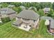 Birds eye view of the home showing brick exterior, patio, and green lawn at 9825 Ardrey Woods Dr, Charlotte, NC 28277