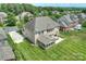 Aerial view of backyard, brick home, patio, and surrounding greenery at 9825 Ardrey Woods Dr, Charlotte, NC 28277