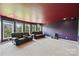 Finished basement with comfortable seating, theater lighting, and an abundance of windows at 9825 Ardrey Woods Dr, Charlotte, NC 28277