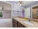 Bathroom with double sink vanity, granite countertop, and decorative lighting fixtures at 9825 Ardrey Woods Dr, Charlotte, NC 28277