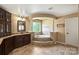 Elegant bathroom featuring a soaking tub, granite counters, and decorative columns at 9825 Ardrey Woods Dr, Charlotte, NC 28277